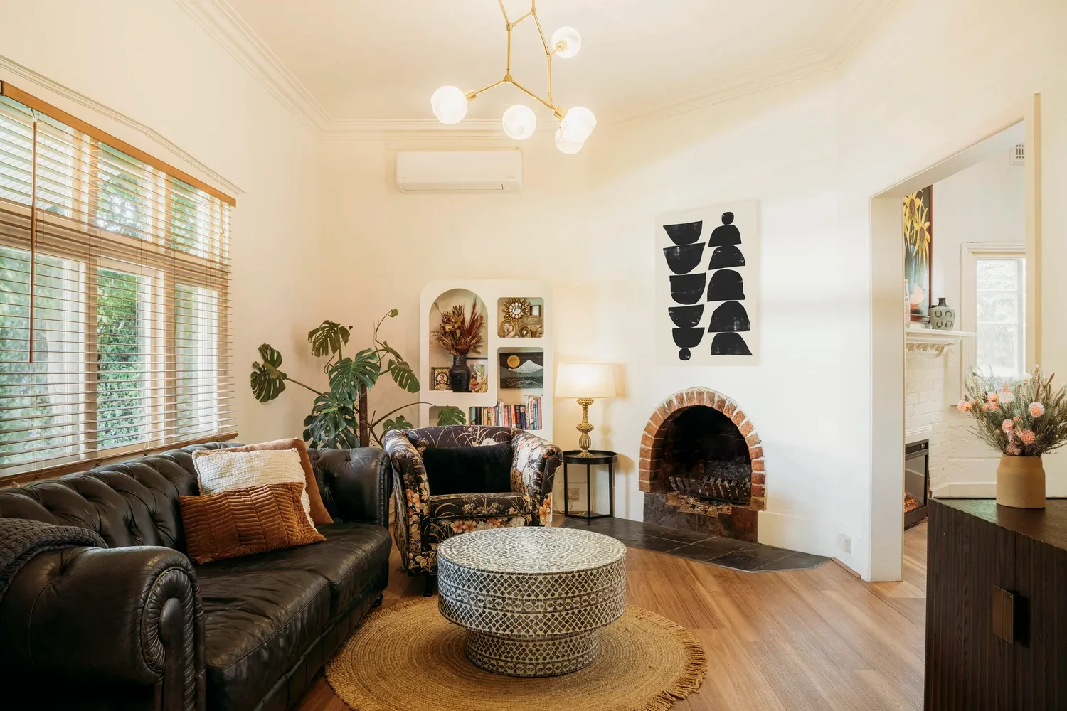 Timber furniture and pale walls in the sitting room.