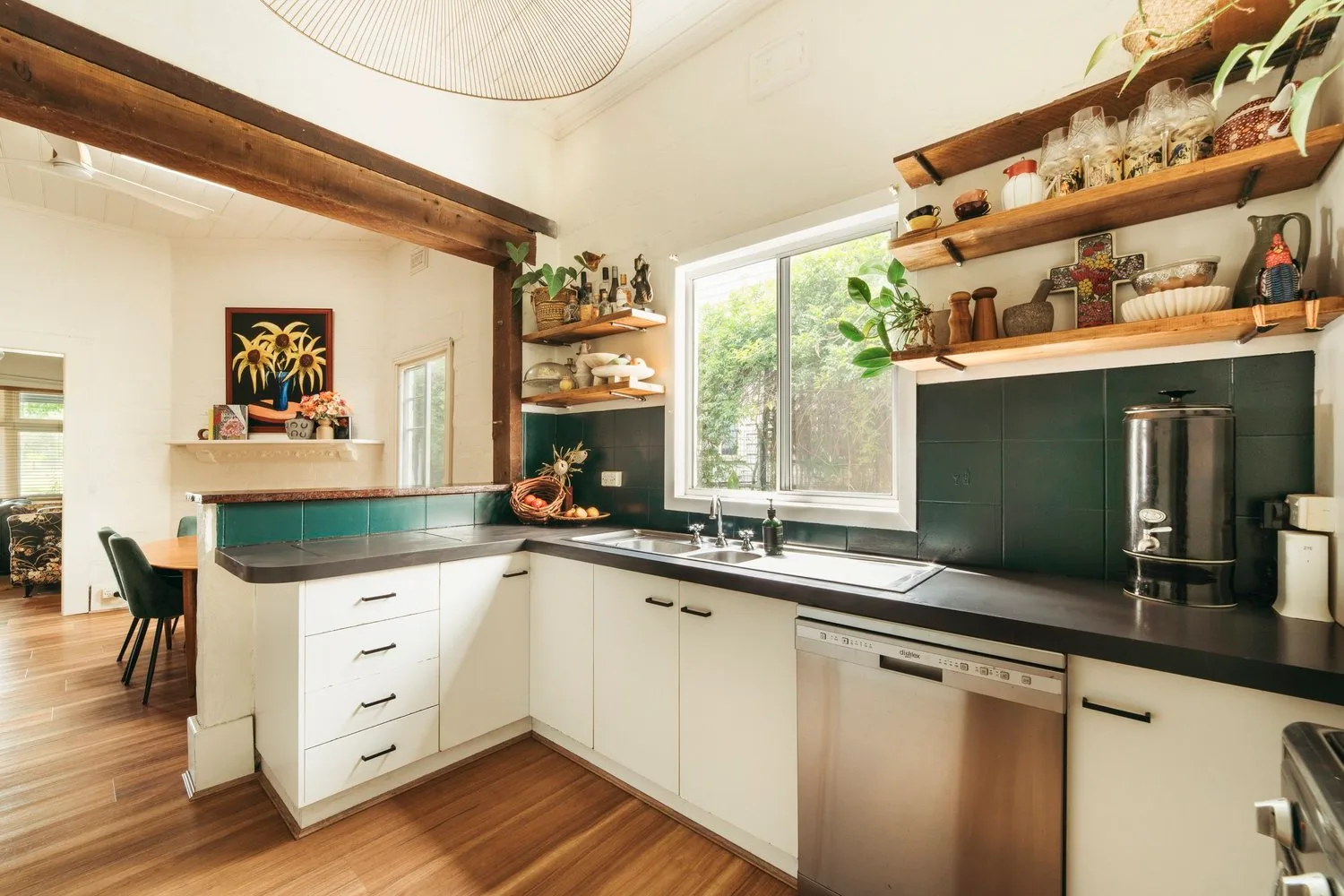 Pale cabinetry and a darker kitchen wall.