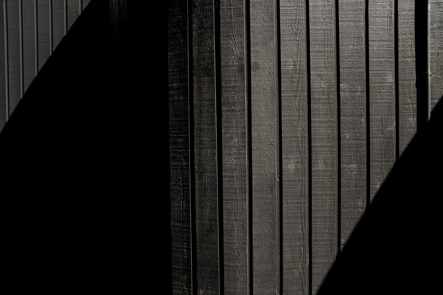 A close view of dark vertical cladding.